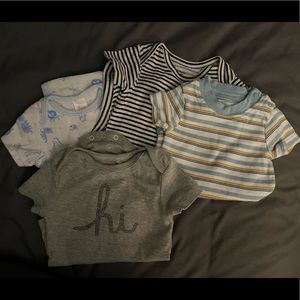 Assorted short sleeve printed baby onsies.